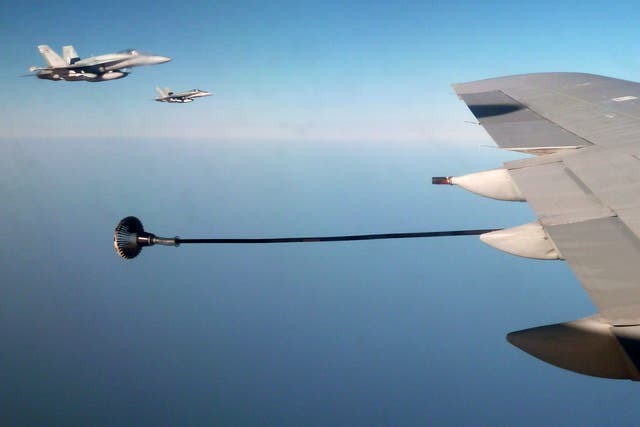 Canadian F-18 war planes (left) wait to refuel from a British VC-10 tanker aircraft