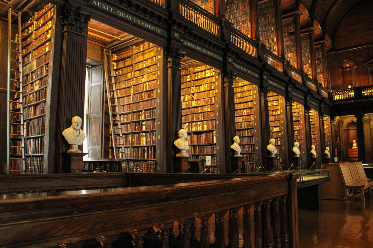Peruse the books in Trinity College library