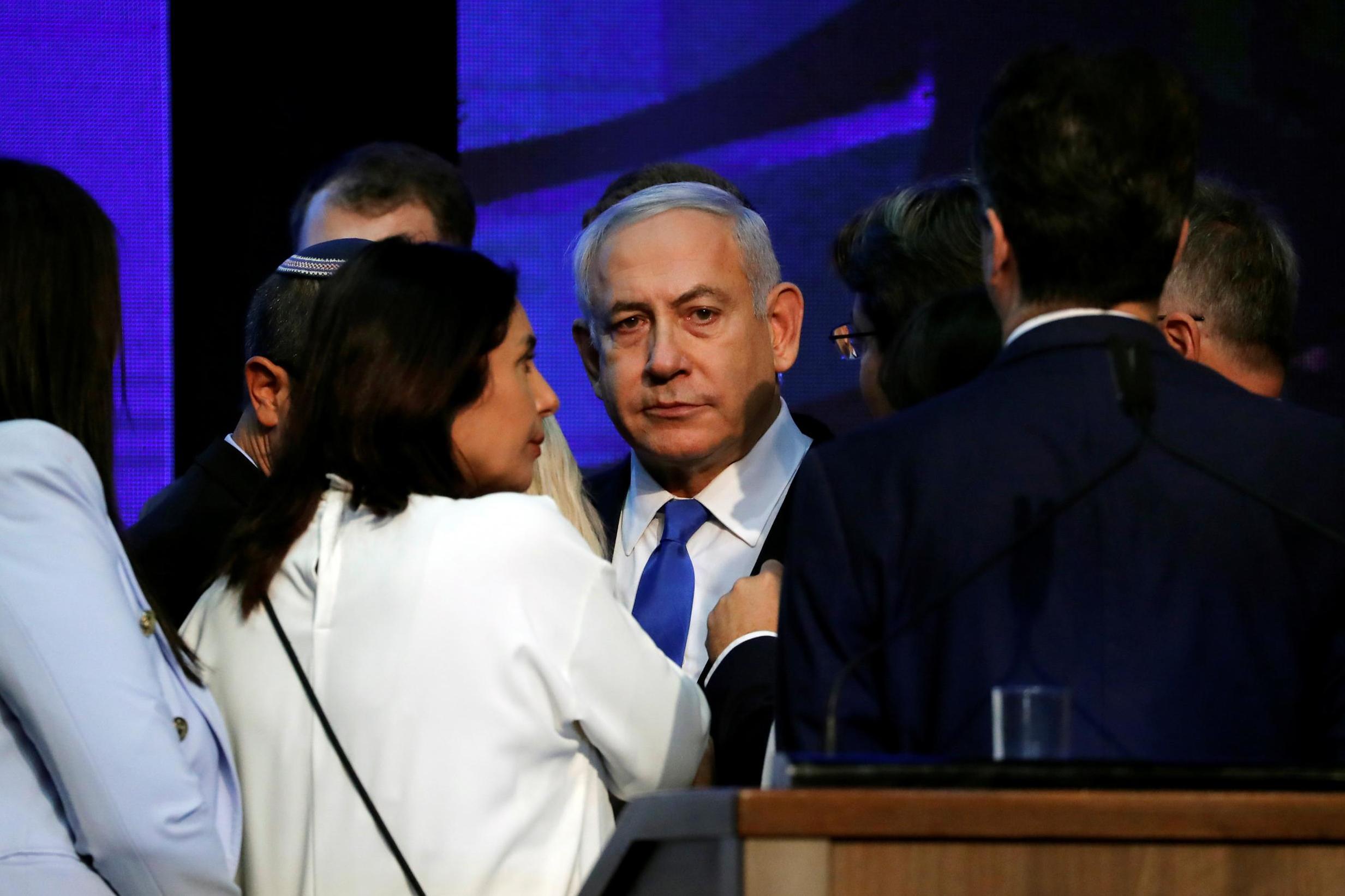 Netanyahu looks on after speaking to supporters at his Likud party headquarters following the announcement of exit polls yesterday