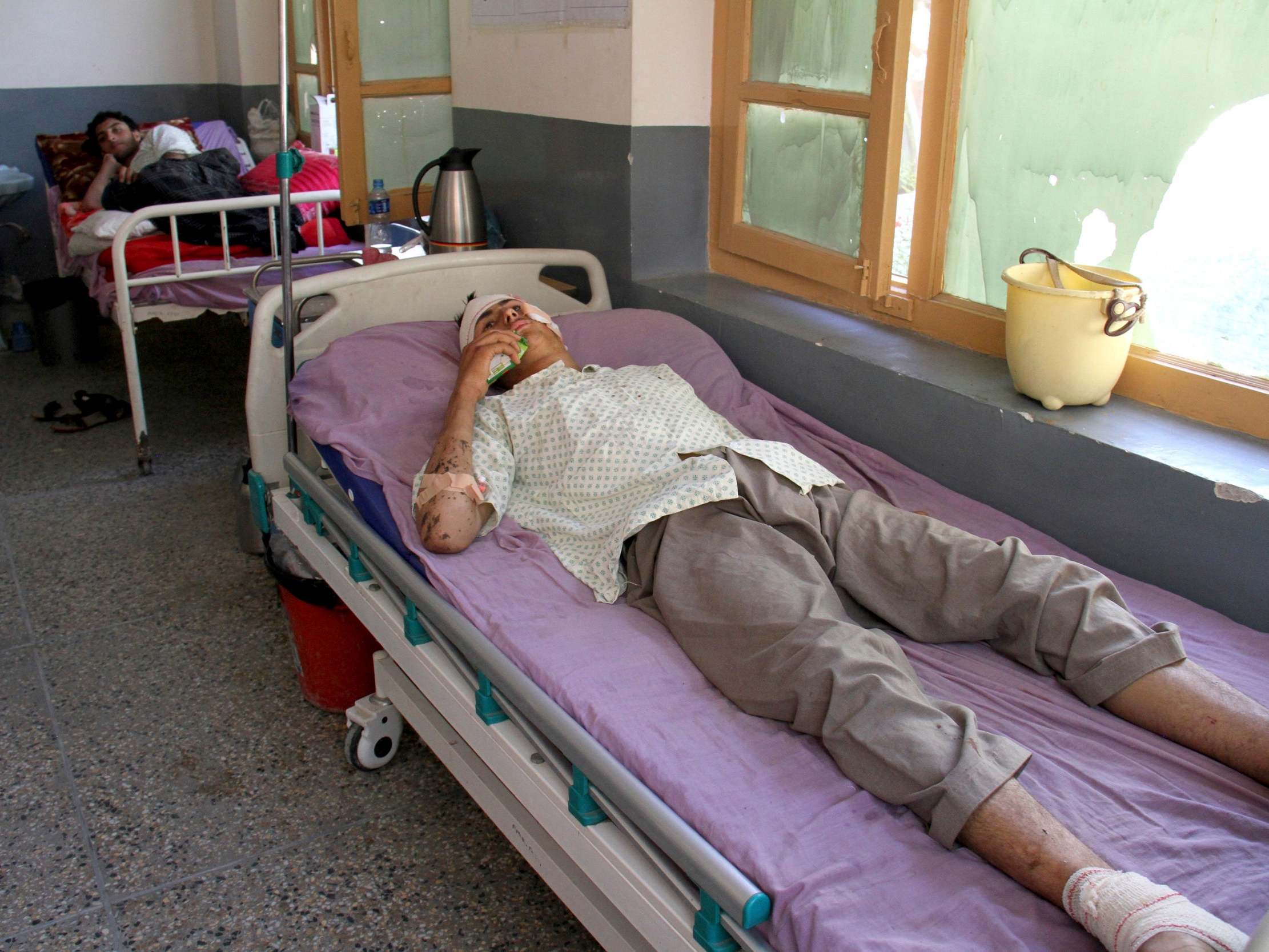 An injured men receives treatment at a hospital after a drone attack in Nangarhar, Afghanistan