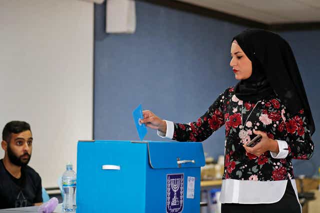 An Arab Israeli woman votes during Israel's parliamentary election at a polling station in Kafr Manda near Haifa on September 17, 2019