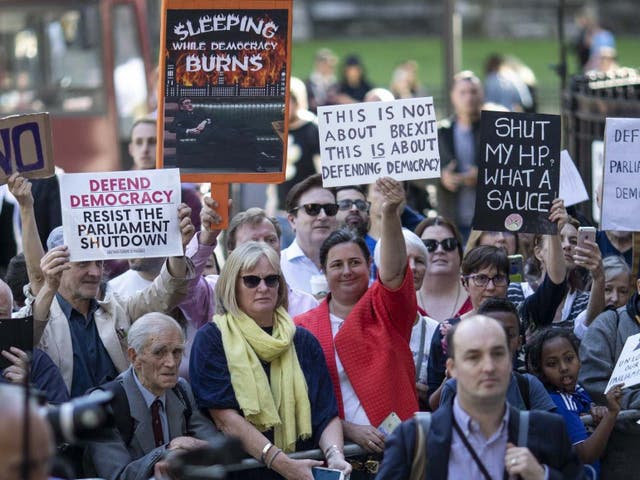 Protesters stand outside the Supreme Court during a hearing on the legality of proroguing Parliament