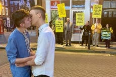 Gay couple win applause for kiss in front of anti-LGBT+ protesters