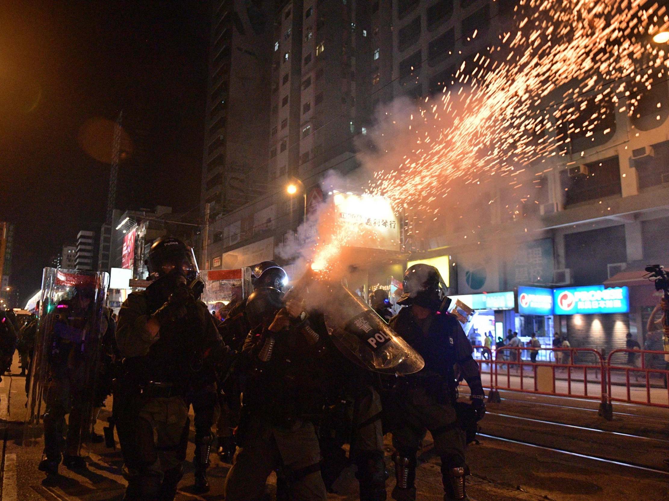 Riot police officers shoot tear gas canisters against pro-democracy protesters in Hong Kong on September 21, 2019