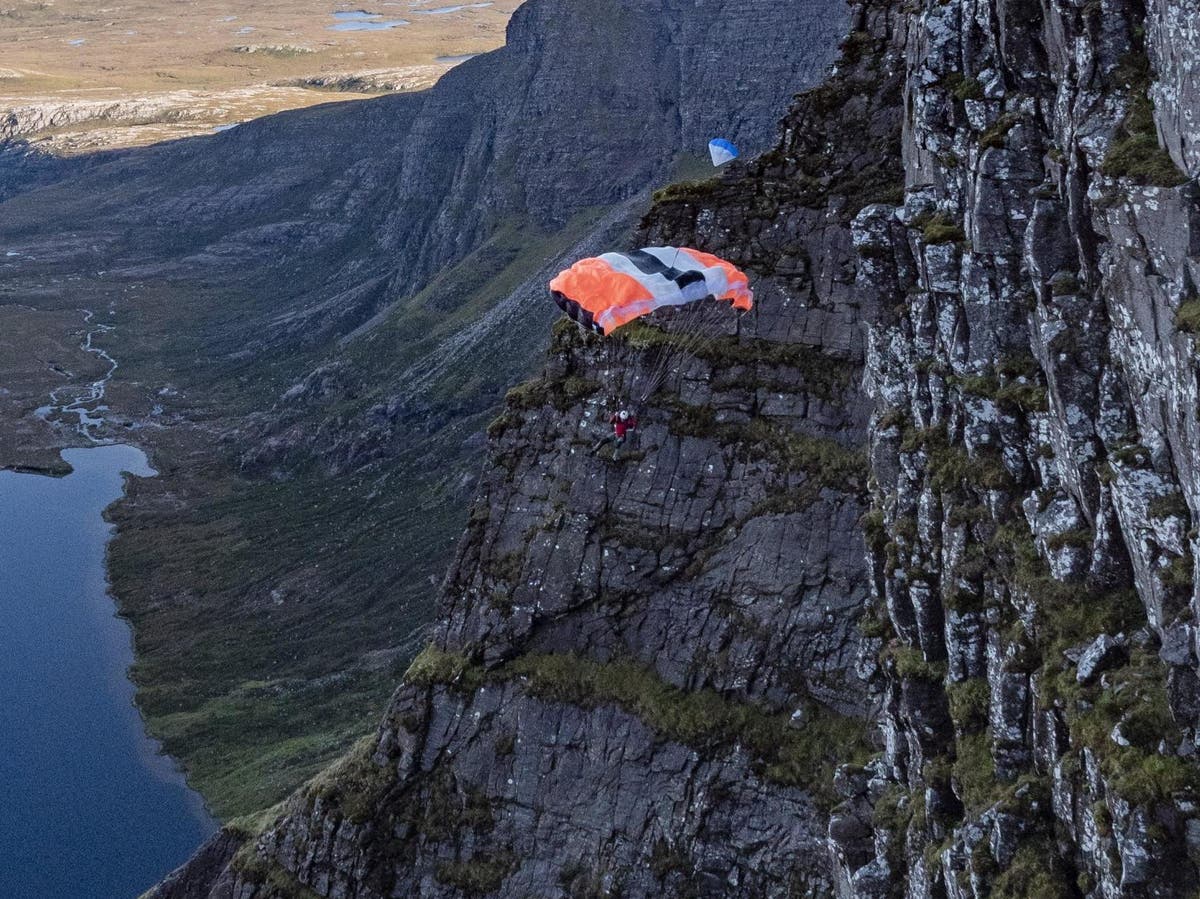 Base jumper smashes into cliff and tumbles 180ft after parachute spins unexpectedly