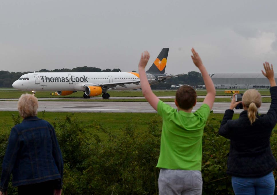  The pilot's family members wave as a Thomas Cook aircraft departs from Manchester Airport
