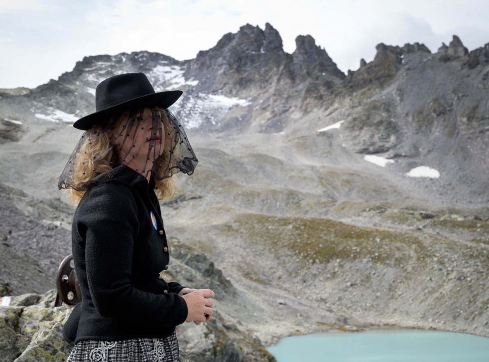 A woman takes part in a ceremony to mark the "death" of the Pizol glacier above Mels, eastern Switzerland