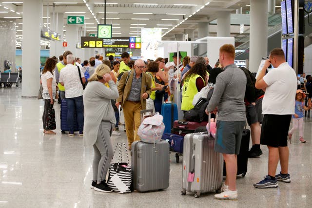 Thomas Cook passengers seeking information at Mallorca airport 