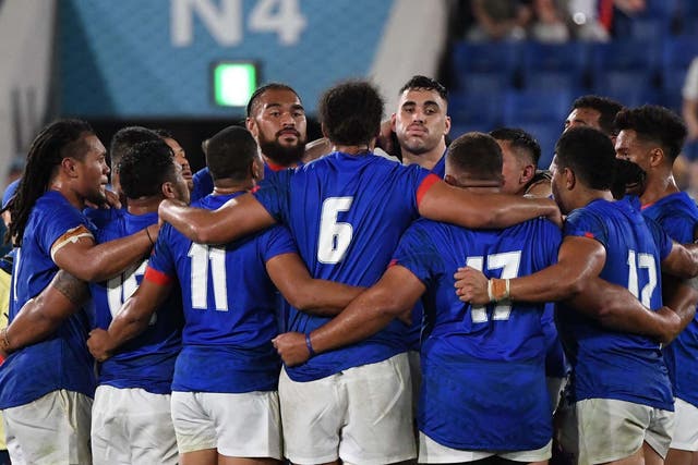 Samoa's players huddle after scoring a sixth try
