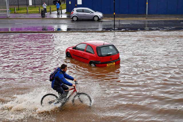 A car sits stranded on a flooded road in Birmingham city centre on Tuesday