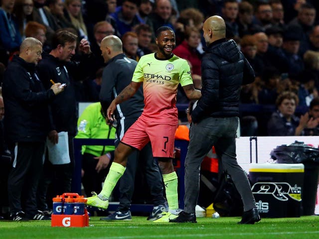 Raheem Sterling laughs with Pep Guardiola as he leaves the field