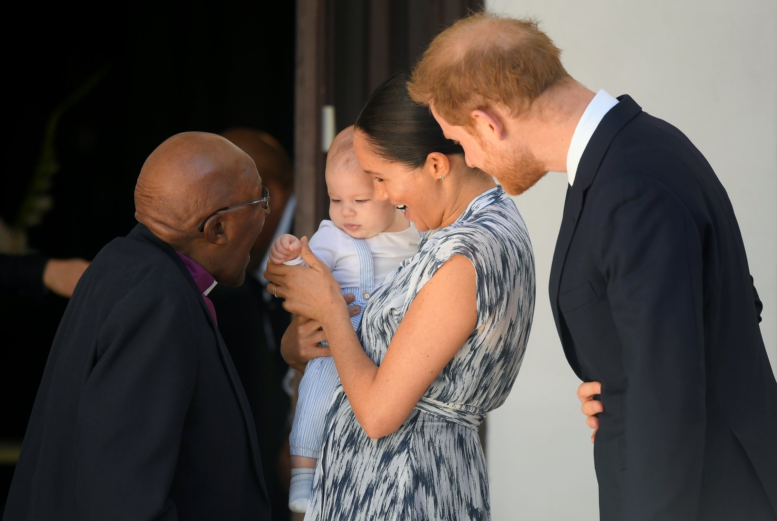 Archbishop Desmond Tutu beams at Archie as he meets the baby royal for the first time.