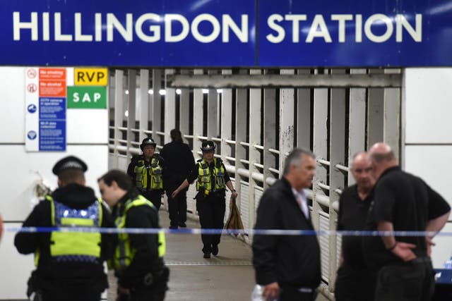 Police outside Hillingdon underground station in London, where a murder investigation has been launched after a man was stabbed to death.