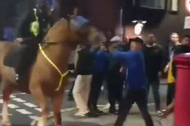 Still image from video footage of a man appearing to punch a horse after a Portsmouth vs Southampton match 24 September, 2019.