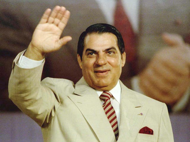 Ben Ali waves to supporters during a Constitutional Democratic rally in 1998
