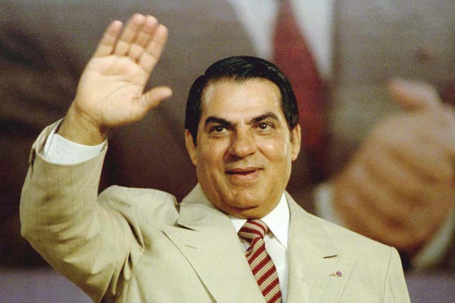 Ben Ali waves to supporters during a Constitutional Democratic rally in 1998