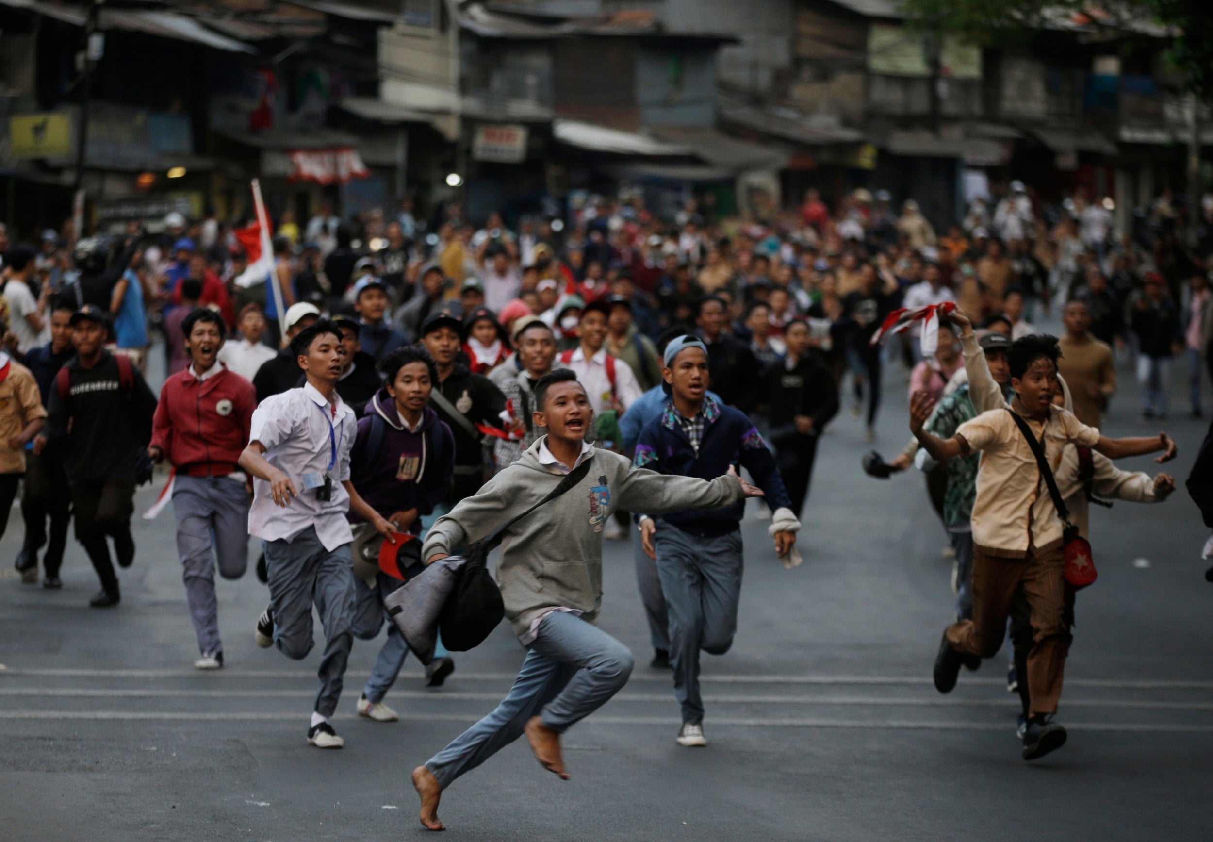 Students run during a protest in Jakarta, Indonesia on Wednesday