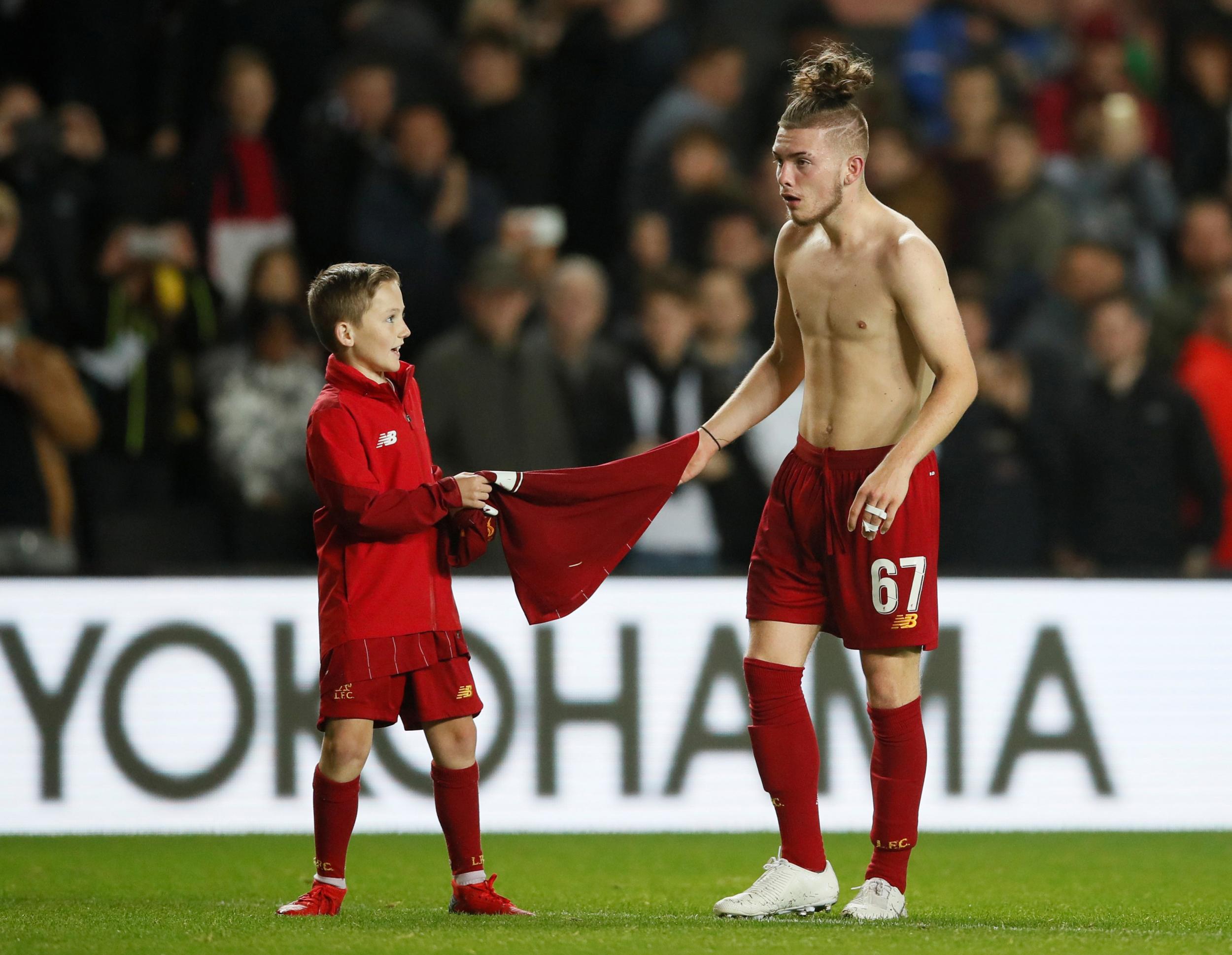 Harvey Elliott hands his shirt to a fan at the final whistle