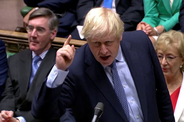 Boris Johnson gestures as he speaks at the parliament