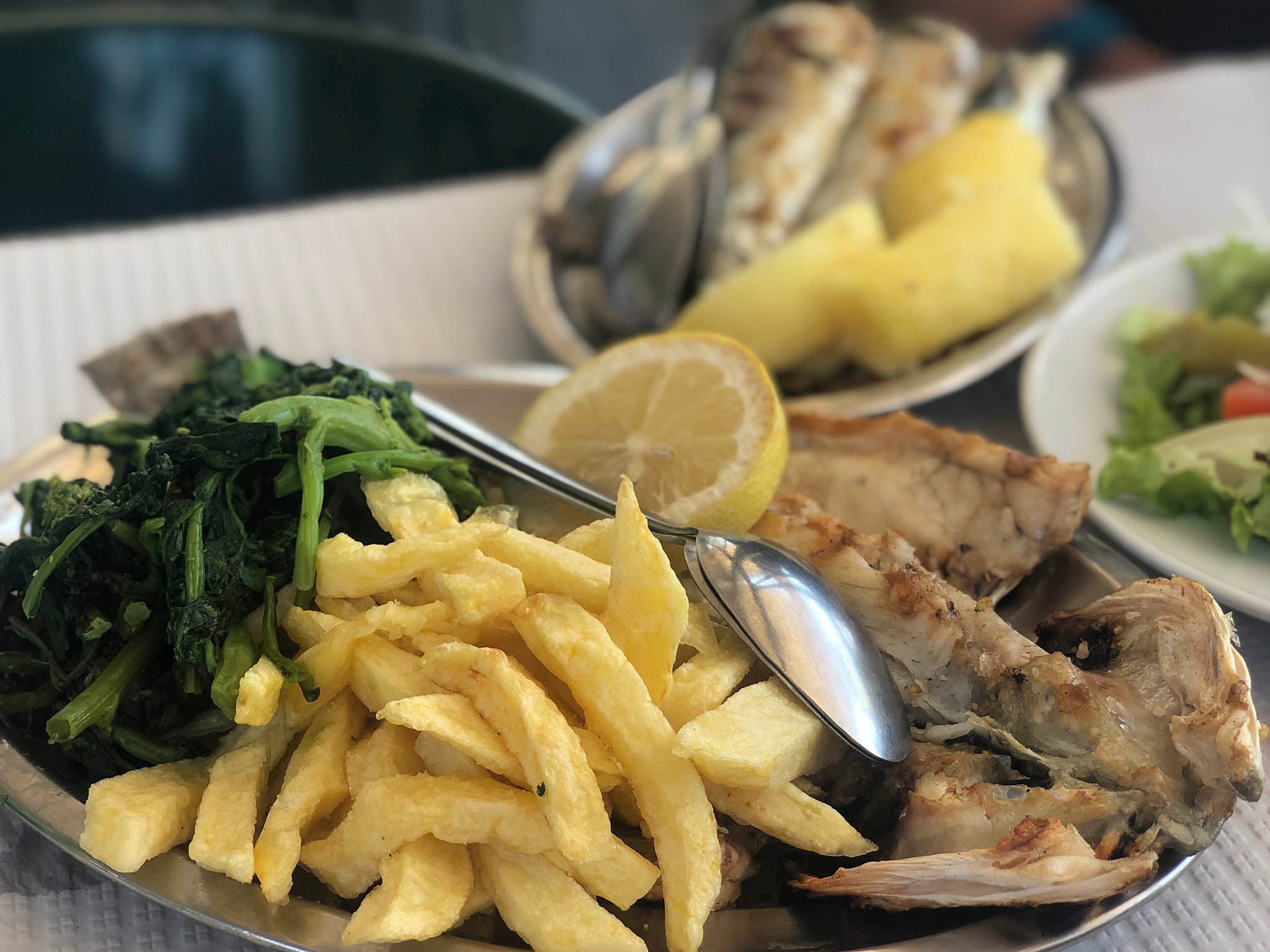 Don’t miss this at Ultimo Porto: fish barbecued over charcoal on an outdoor grill, served with butter and lemon and boiled vegetables