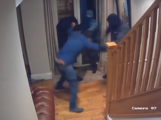 An estate agent fought off a gang of robbers who raided his home
