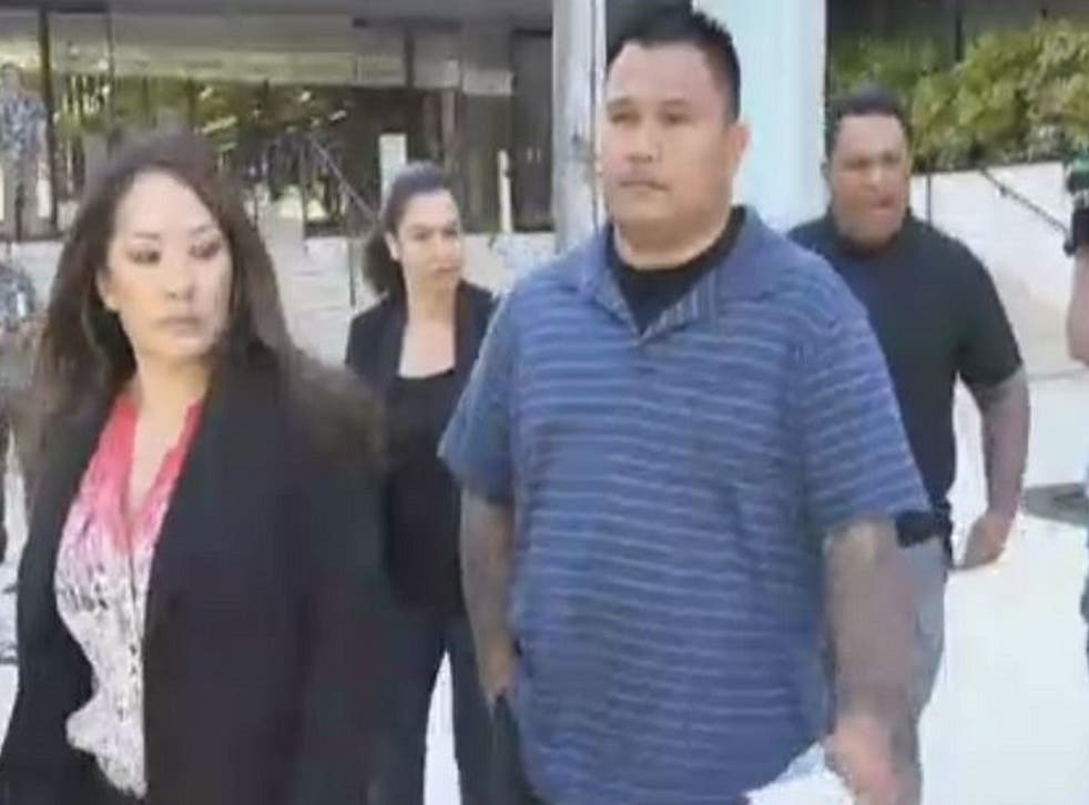Honolulu police officer John Rabago (left, in blue) and Reginald Ramones (right, in black) are accused of forcing a homeless man to lick a urinal.