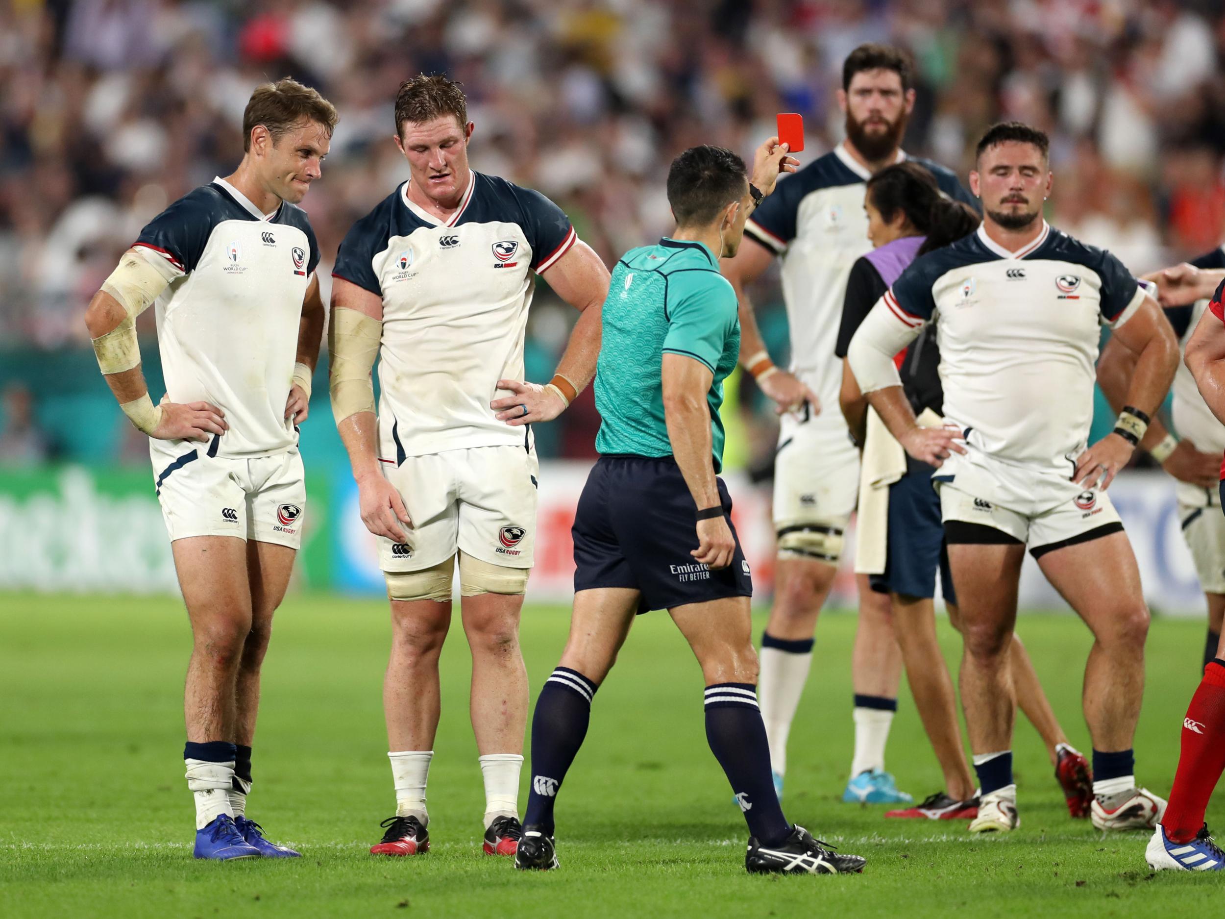 Referee Nic Berry produced the first red card of the World Cup, with the USA’s John Quill sent off