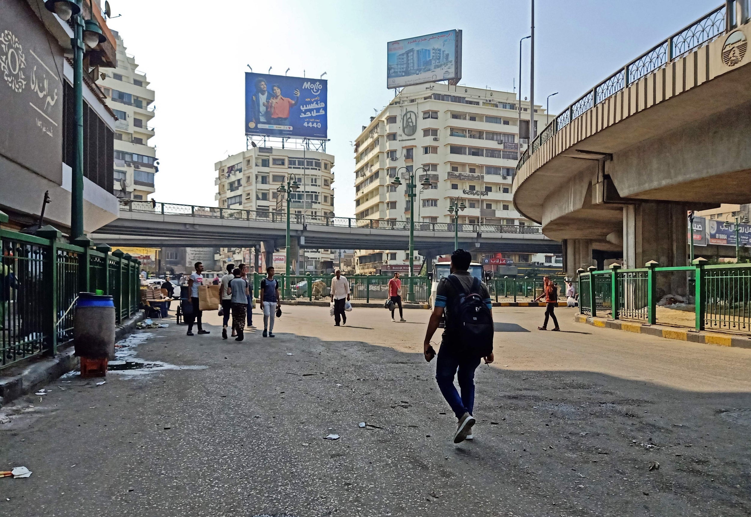 Egyptians walk around Cairo's Giza square on Friday