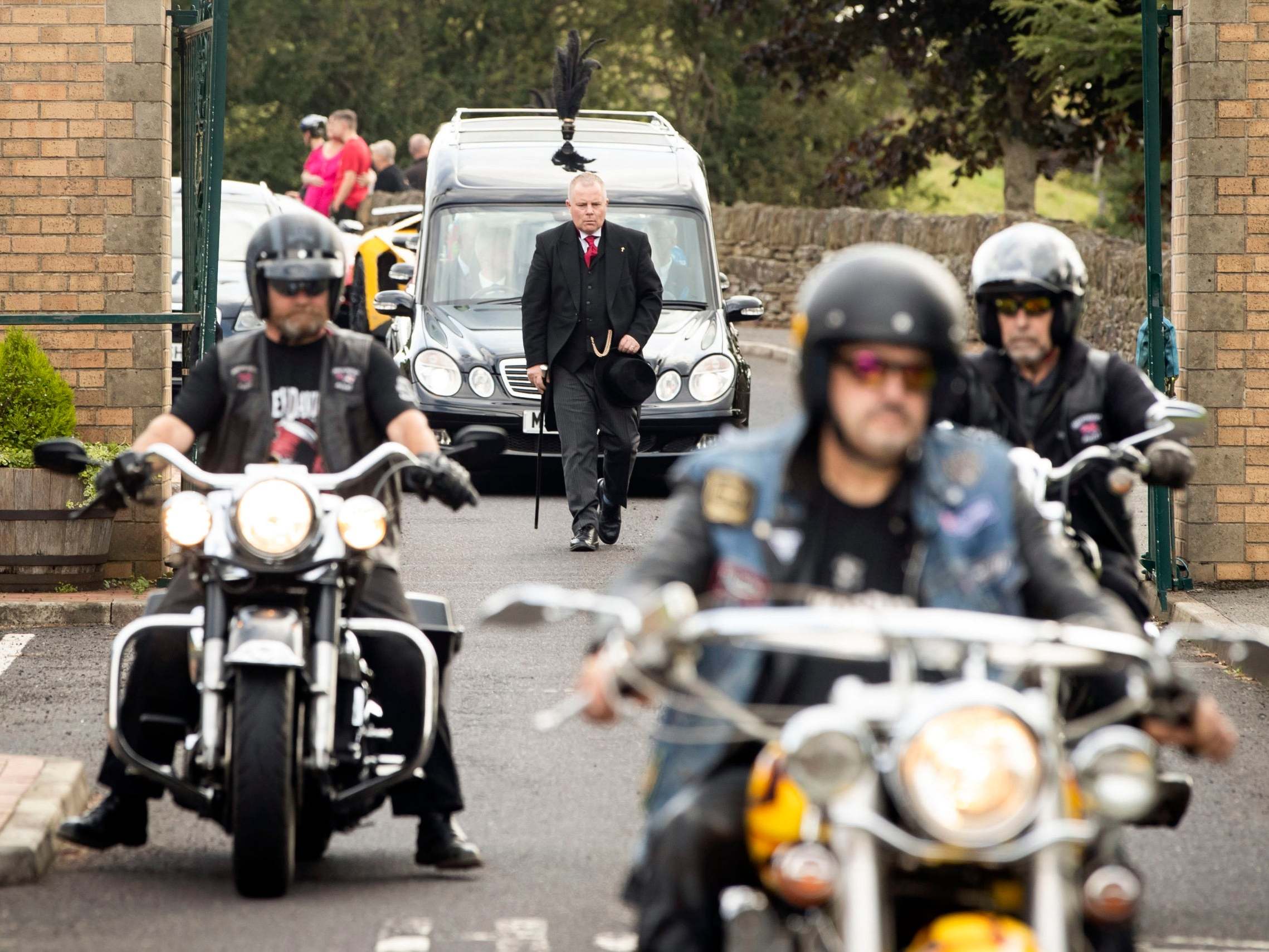 Motorbikes escort the funeral cortege arriving at Grenoside Crematorium, Sheffield, prior to the funeral of Tristan and Blake Barrass, 8 August, 2019.