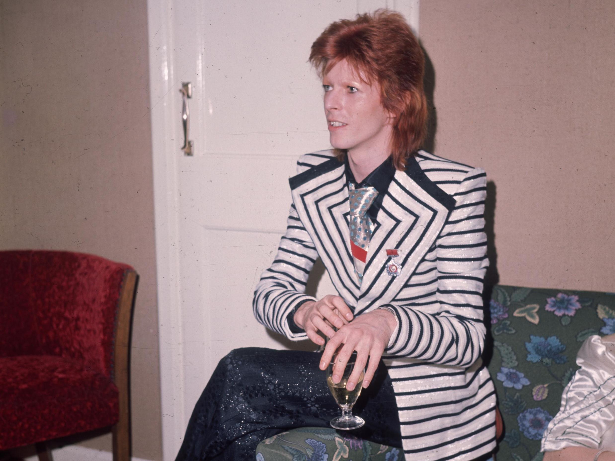 Bowie’s glam period, back in May 1973, in black and white horizontally striped jacket with wide lapels (Getty)
