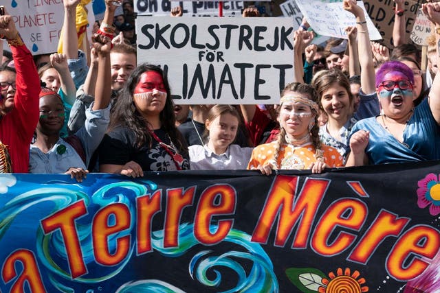 Swedish activist and student Greta Thunberg, centre, takes part in the Climate Strike in Montreal on Friday 27 September