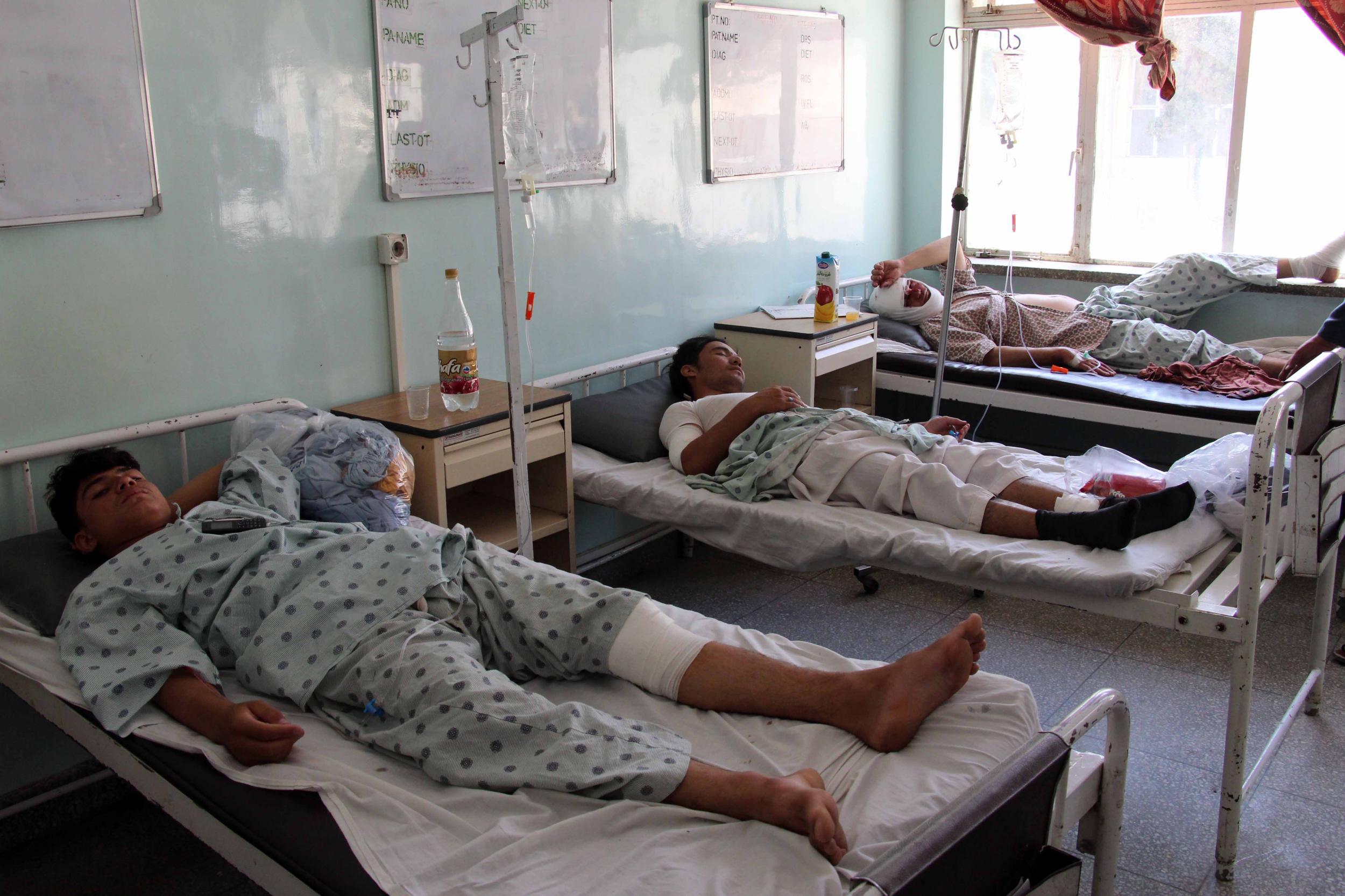 Victims of a bomb outside a polling station are treated at a hospital in Kandahar