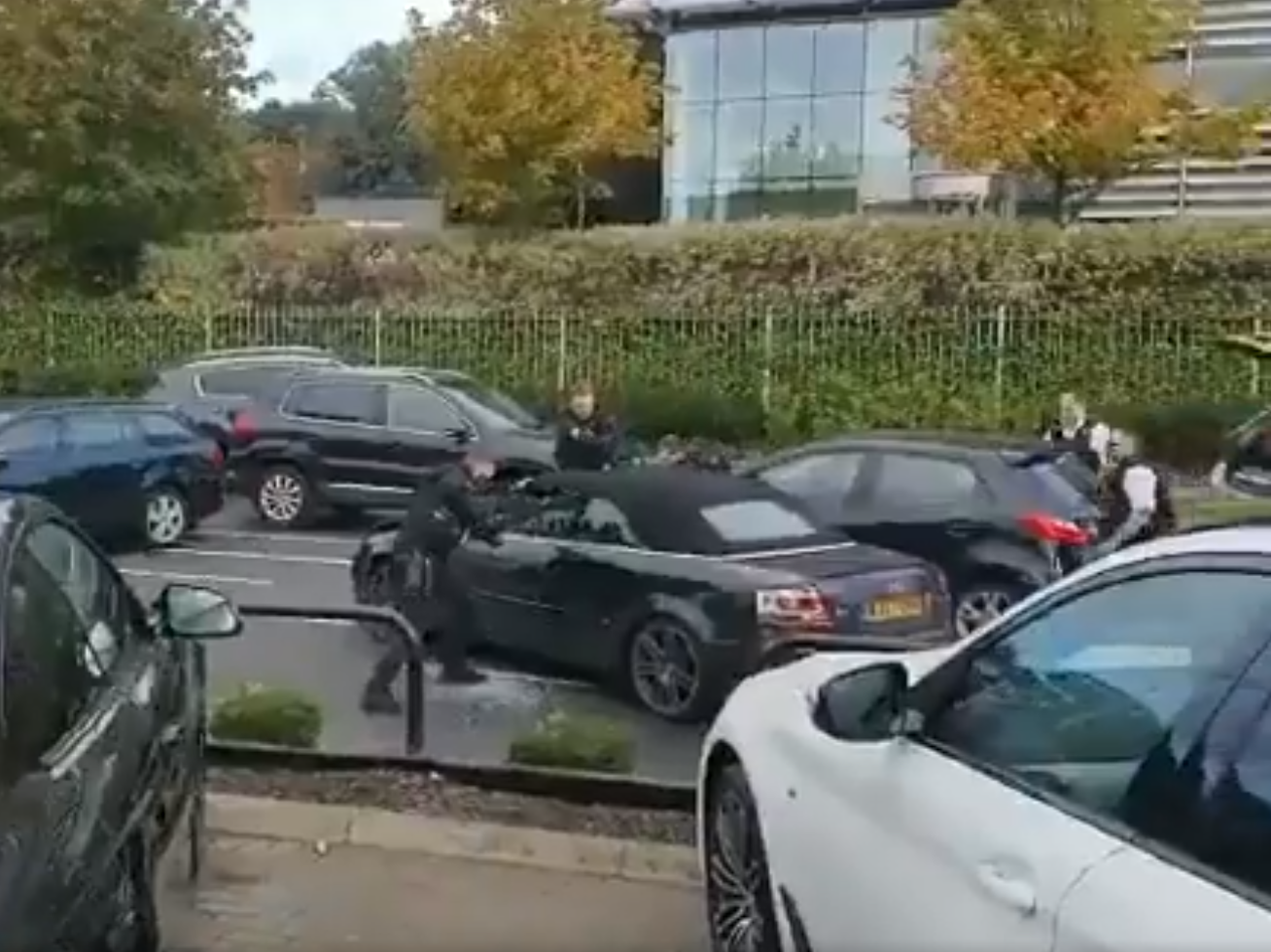 Armed police officers point their rifles at the teenagers inside the car after a high-speed chase