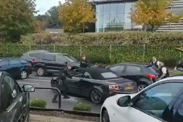 Armed police officers point their rifles at the teenagers inside the car after a high-speed chase