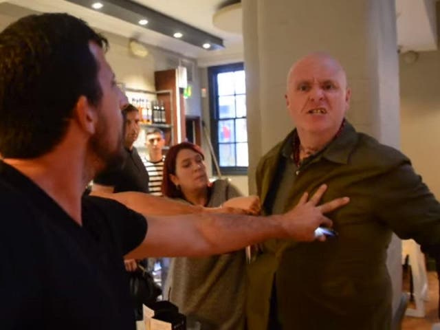 Screenshot from a video of a man punching a female vegan activist at a Pizza Express in Brighton