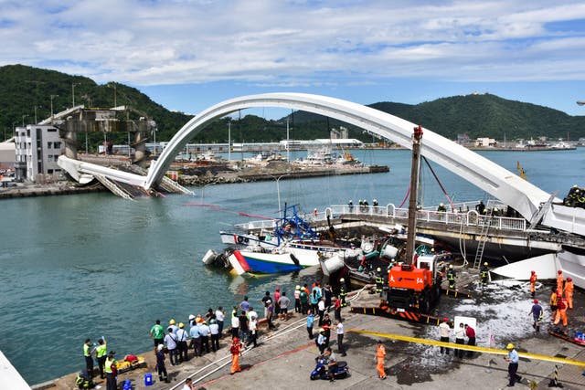 Rescuers work near the site of a collapsed bridge in Nanfangao, eastern Taiwan