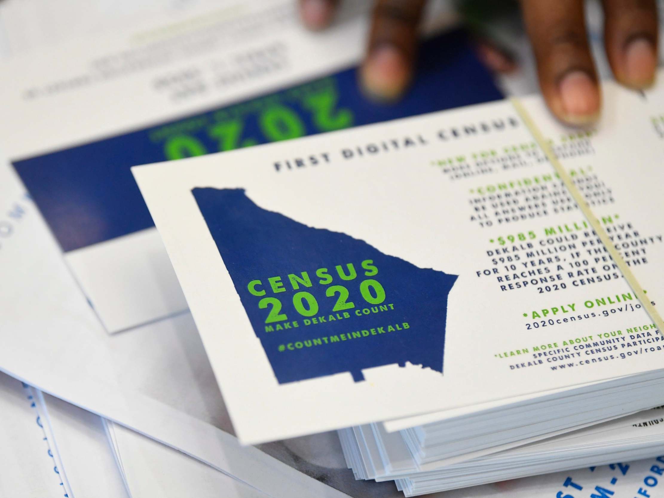 A worker gets ready to pass out instructions on how to fill out the 2020 census during a town hall meeting in Lithonia, Gerogia