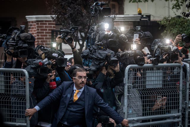 A man tries to hold back the press outside the Saudi Arabian consulate in Istanbul after Khashoggi’s disappearance last October