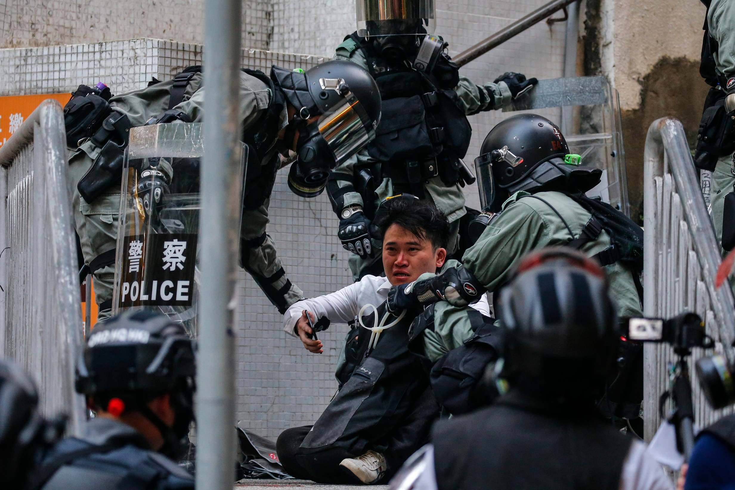 An anti-government protester is arrested by police officers protesting during China National Day