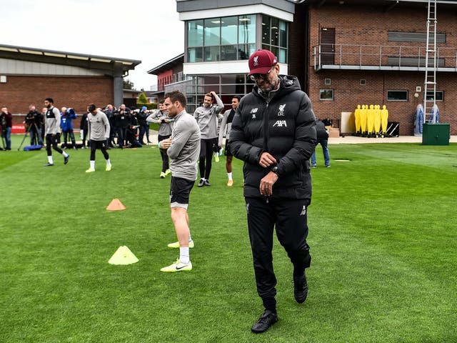 Jurgen Klopp strides on to the training field at Melwood