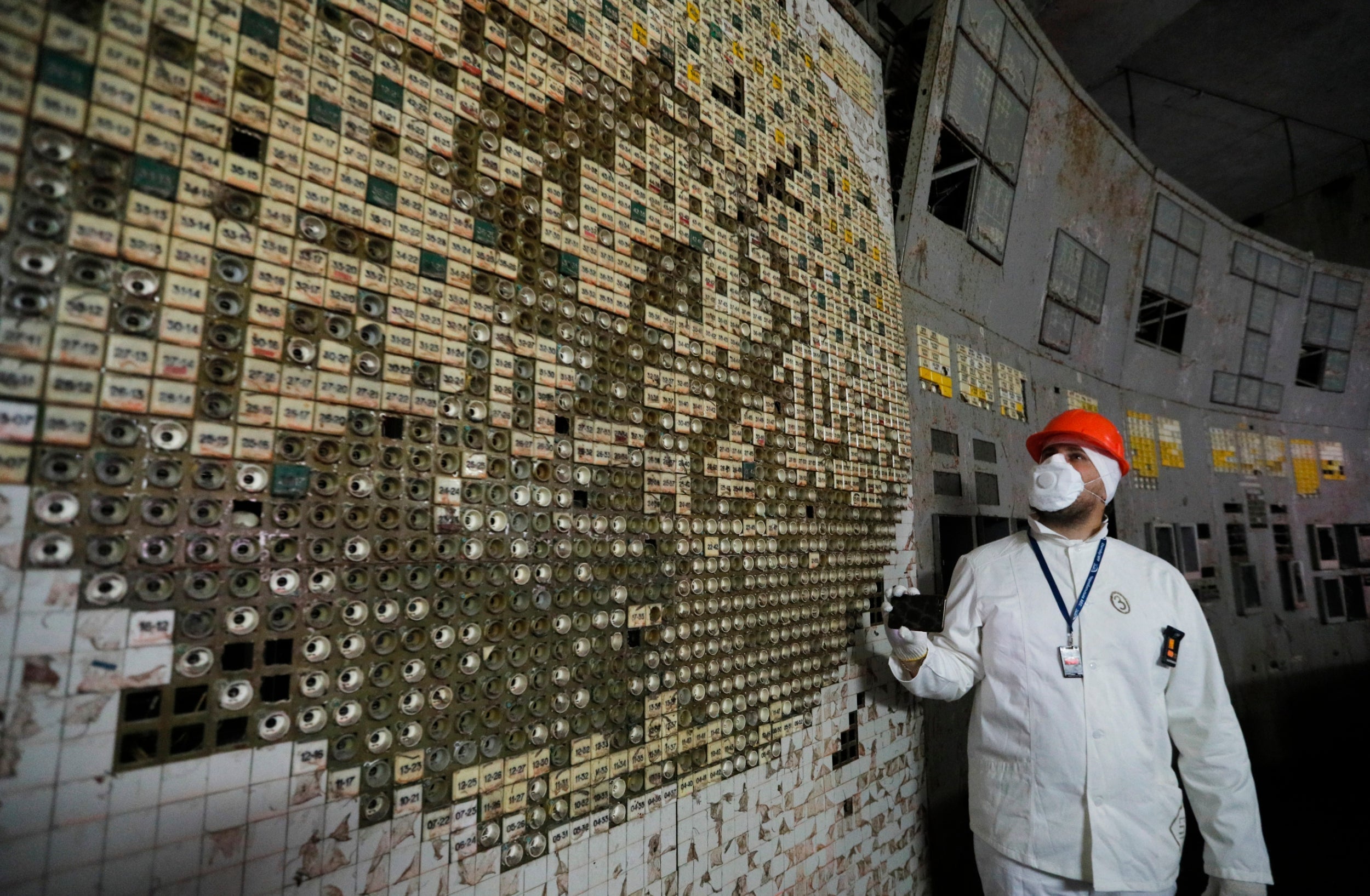 Journalists visit the control room of the plant's fourth reactor at the Chernobyl nuclear power plant