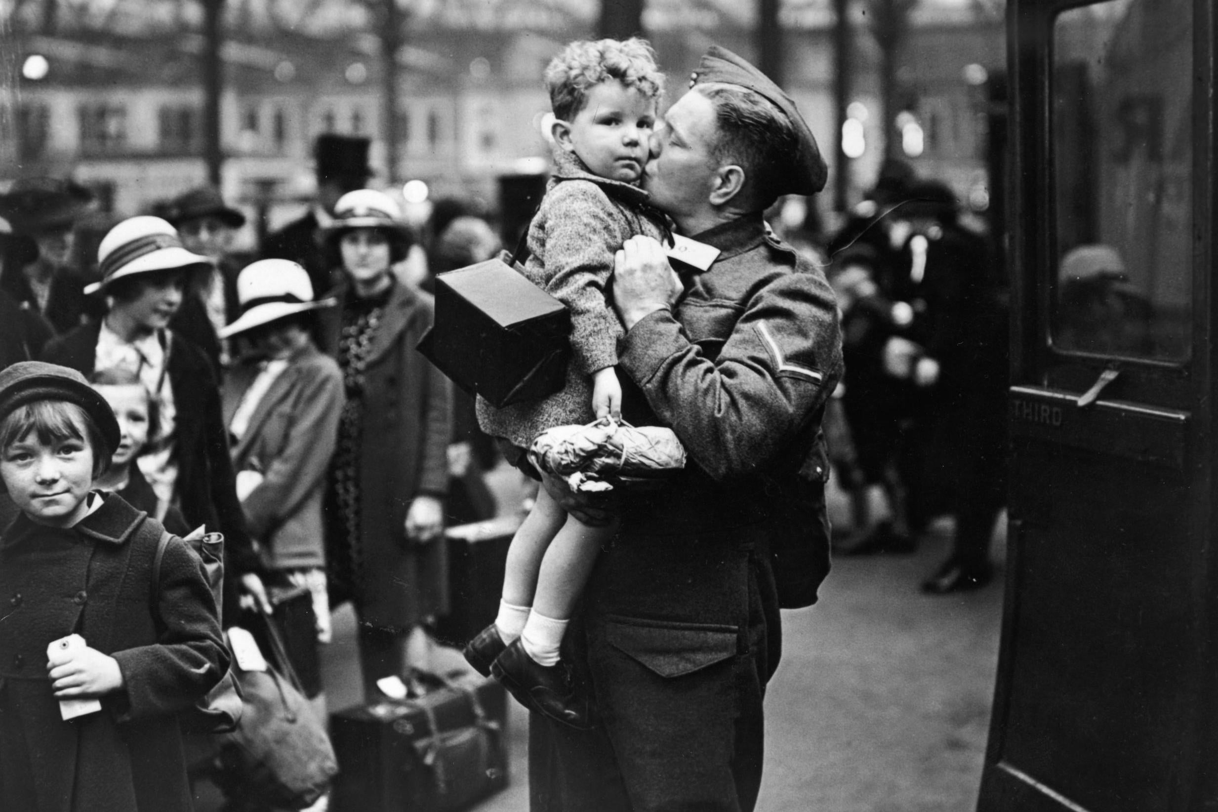 A soldier home on leave from the British Expeditionary Force says goodbye to his baby son at the evacuation point in London in June 1940 (Getty)