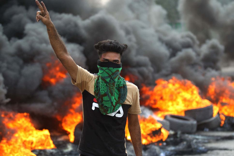 An Iraqi protester flashes the V-sign during a demonstration in Baghdad’s Baladiyat district on Wednesday