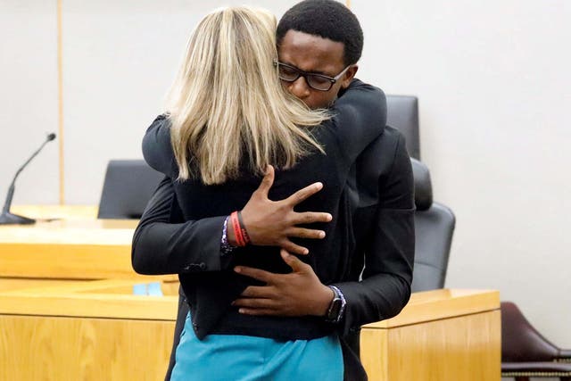 Botham Jean's younger brother Brandt Jean hugs former Dallas police officer Amber Guyger after delivering his impact statement to her following her 10-year prison sentence for murder
