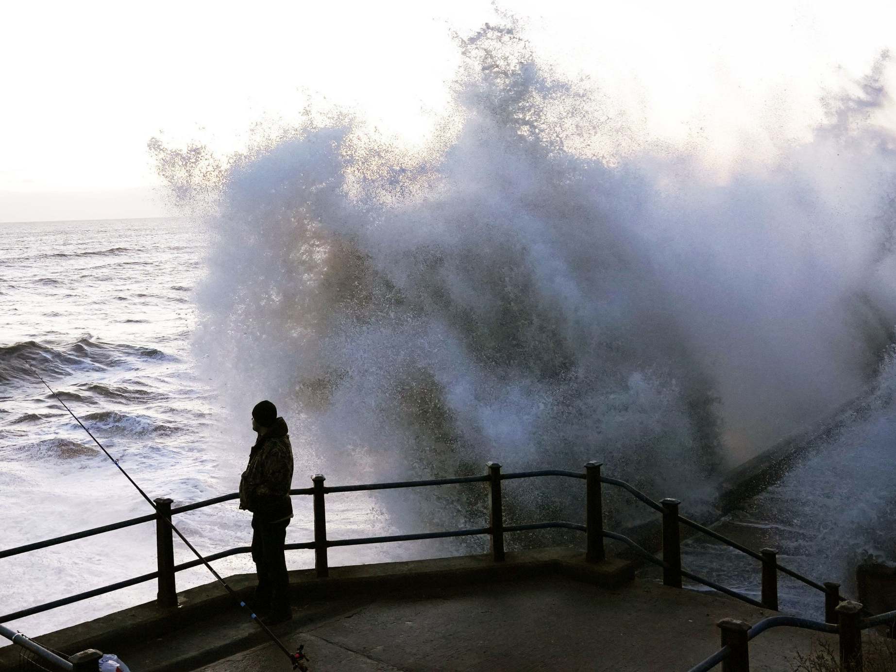 Waves crash against a sea wall in Durham