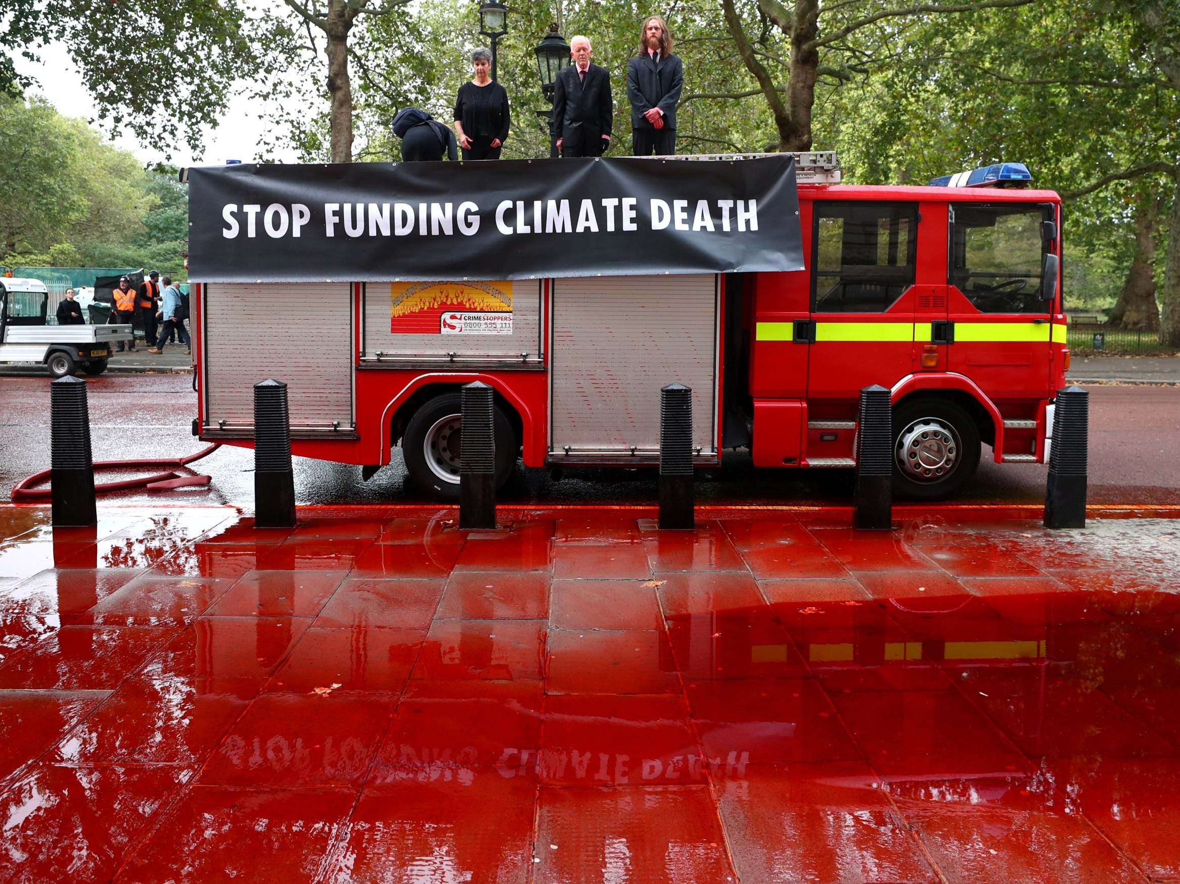 Extinction Rebellion activists arrested after using fire engine to spray Treasury with 1,800 litres of fake blood