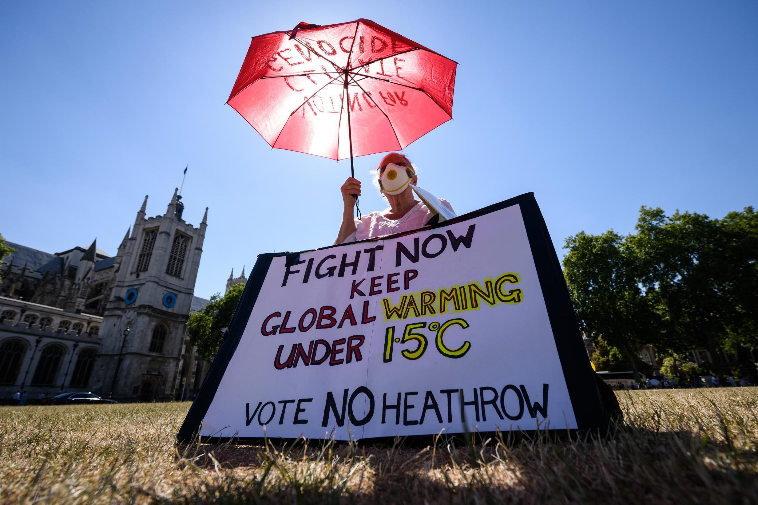 Environmental campaigner Genni Scherer protesting against a proposed third runway at Heathrow airport, already the biggest single source of greenhouse gases in the UK, outside the House of Parliament
