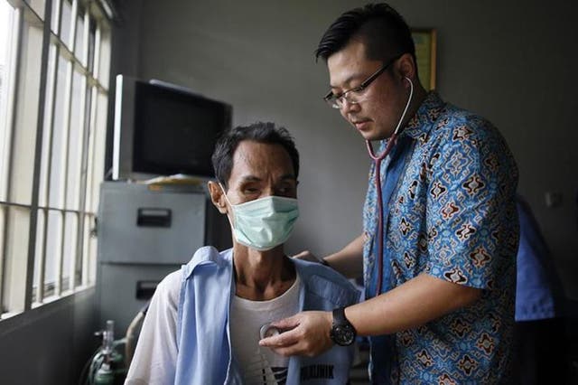 Global disease: a doctor treats a TB prisoner in Jakarta, Indonesia