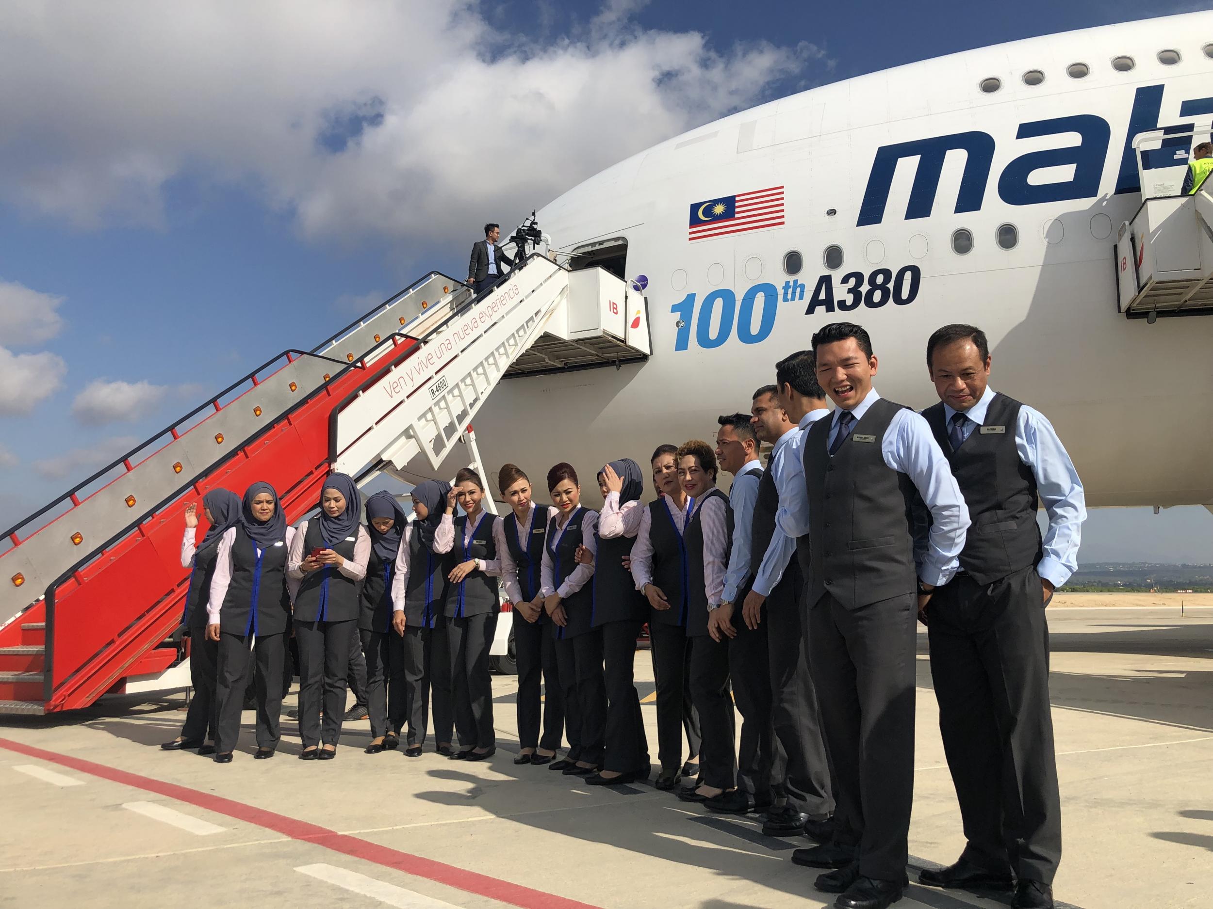 Welcome aboard: Malaysia Airlines cabin crew at Palma airport, waiting for passengers to board a ‘rescue flight’ to Manchester