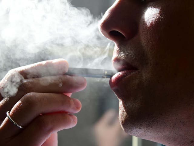 In this file photo taken on October 02, 2018 shows a man exhaling smoke from an electronic cigarette in Washington